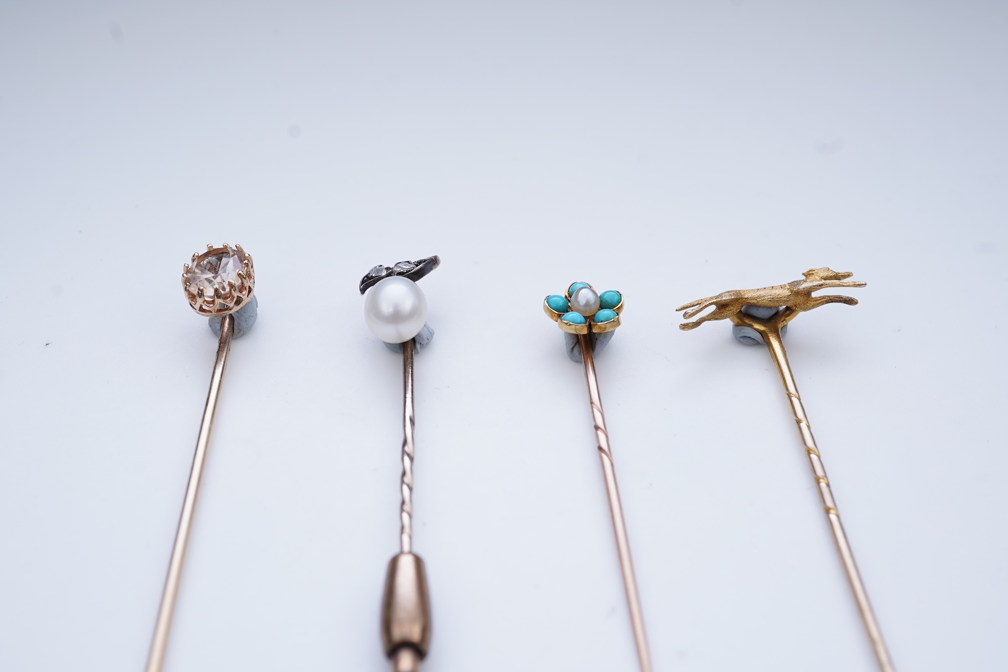 A collection of four tie pins, circa 1900